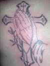 Micks cross and hands tattoo