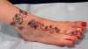 foot with flowers tattoo