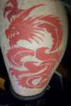 red tribal dragon tattoo