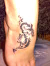 indre's tribal dragon on her foot tattoo