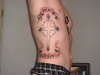 rib cross tattoo