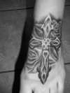 Cross on foot tattoo