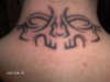 tribal skull face tattoo