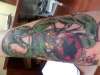 Forearm, spider eating a snake tattoo