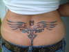 wings/ eyes etc lower back tattoo