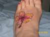 hibiscus ontop of my foot tattoo