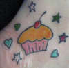 Cupcake with hearts and stars tattoo