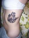 hand holding a heart tattoo