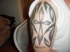 cross with tribal outline tattoo