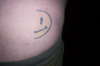 half smilyface tattoo