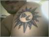 Sun and initials tattoo