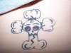 skull w/ afro puffs tattoo