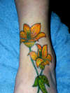 Flowers on ankle and foot tattoo