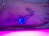 UV flower on foot tattoo