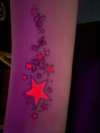 UV stars and initials tattoo