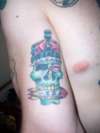 skull wearing the crown of England w/ and IRA bomb in the mouth tattoo