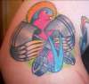 Swallow holding pistons tattoo