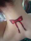 red bow on neck tattoo