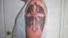 cross on arm tattoo