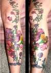 More flowers addes to leg of roses tattoo