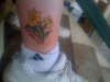 My son's birthflower and birthdate tattoo