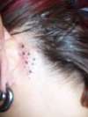 stars behind ear tattoo
