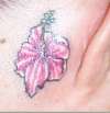 Hibiscus flower behind ear tattoo