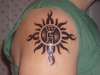godsmack sun with kids initials tattoo