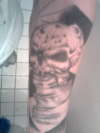 skull on inner arm tattoo