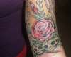 Decaying rose with baby bud and zombie skulls tattoo