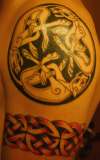 Three intertwined dogs and Celtic knot tattoo