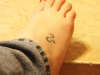 Leo sign on right foot tattoo