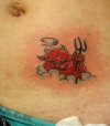 Cute devil on abdomen tattoo