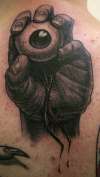 Hand Holding Eye tattoo