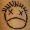 Distillers face tattoo