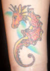 red baby dragon tattoo