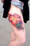 Abstract flower on leg tattoo