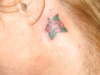 Rose behind left ear tattoo
