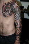biomech arm and chest tattoo