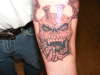 skull/wings/injection stacks tattoo