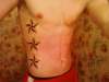 3 Nautical Stars going down ribs tattoo