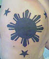3 stars and a sun tattoo