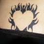 Black heart lowerback tattoo