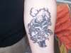 Dragon Revolving around a skull tattoo