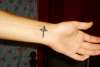 Cross on wrist tattoo