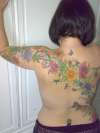 Flower back tattoo......continued....arm...now coloured! tattoo