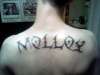 Last name on back tribal letters tattoo
