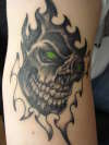 Skull w/ green eyes tattoo