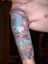 Half Sleeve with a small coverup tattoo