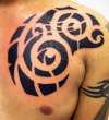 negative space tribal on chest tattoo